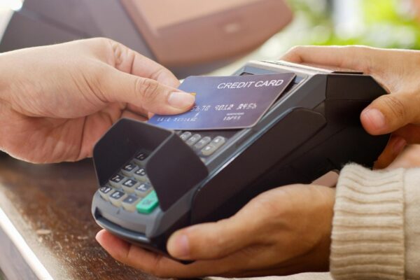 Customer using credit card for payment to owner at cafe restaurant cashless technology and credit card payment concept