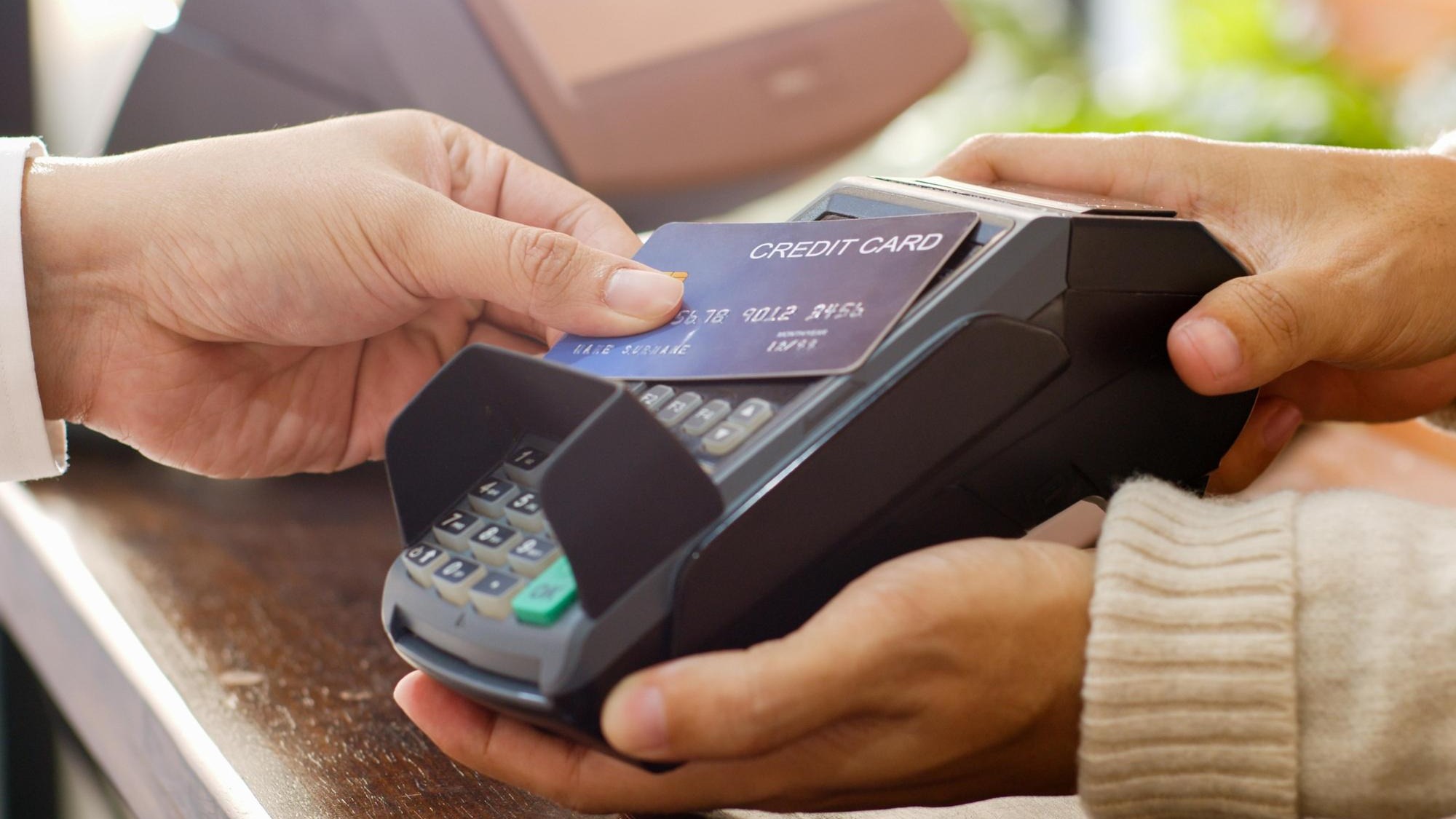 Customer using credit card for payment to owner at cafe restaurant cashless technology and credit card payment concept