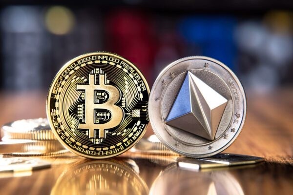 A photo of a Bitcoin and Ethereum coin with a blockchain