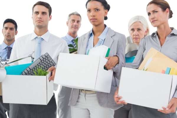 Employees carrying boxes after job loss