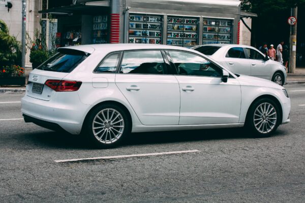 white sedan parked near white building during daytime