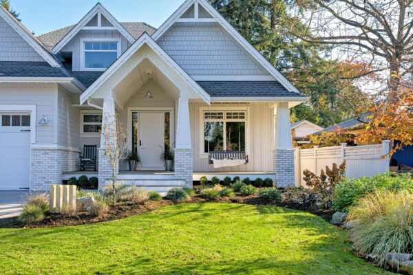 Residential house with open patio at the entrance doors under the porch