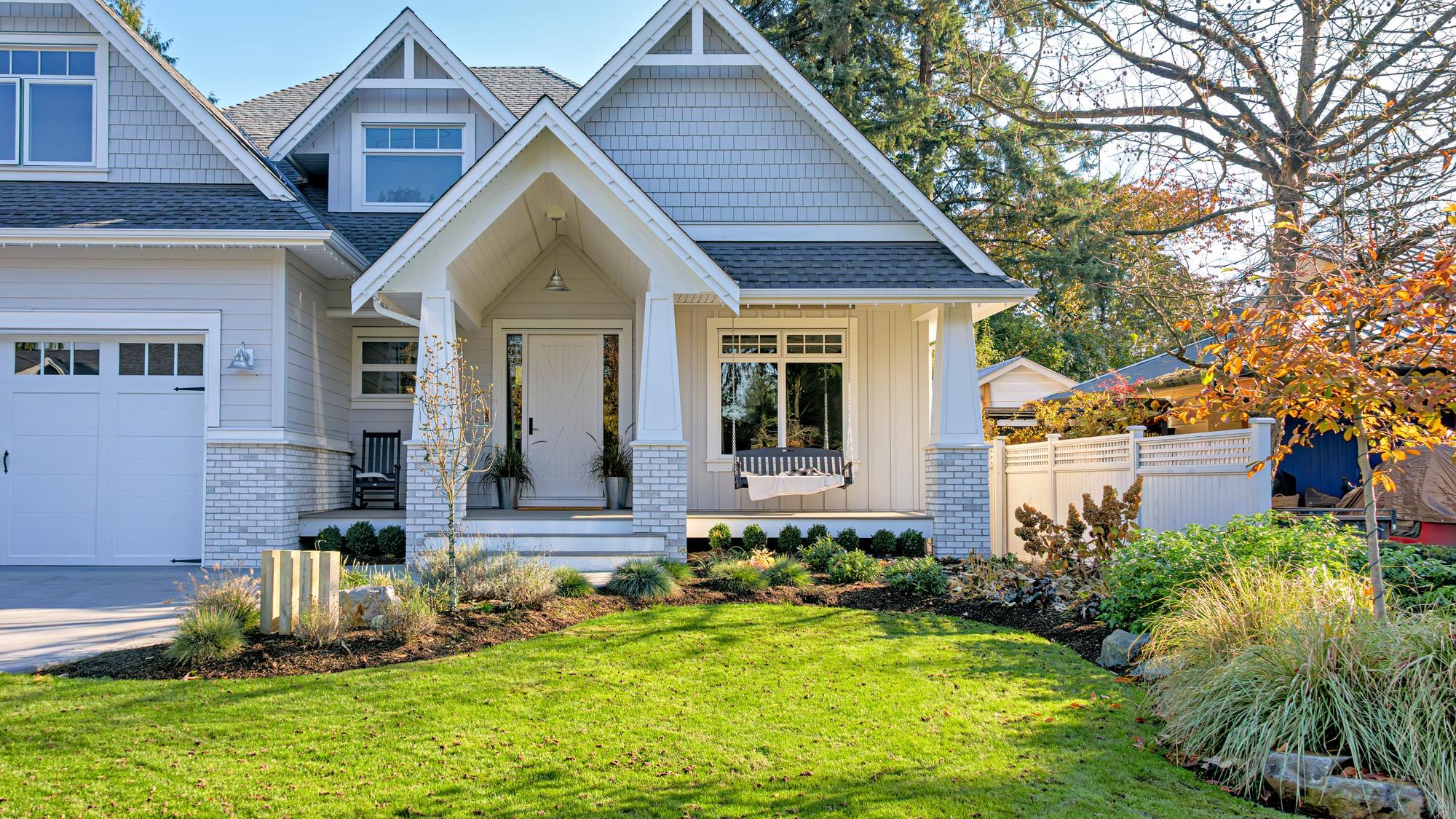 Residential house with open patio at the entrance doors under the porch