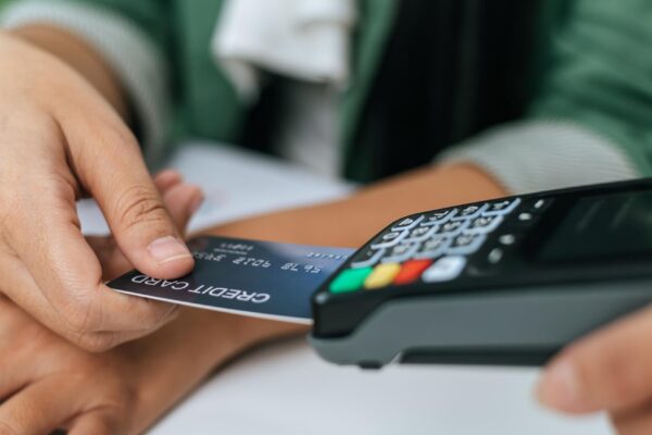 Young businesswoman paying order having contactless payment with cardit card