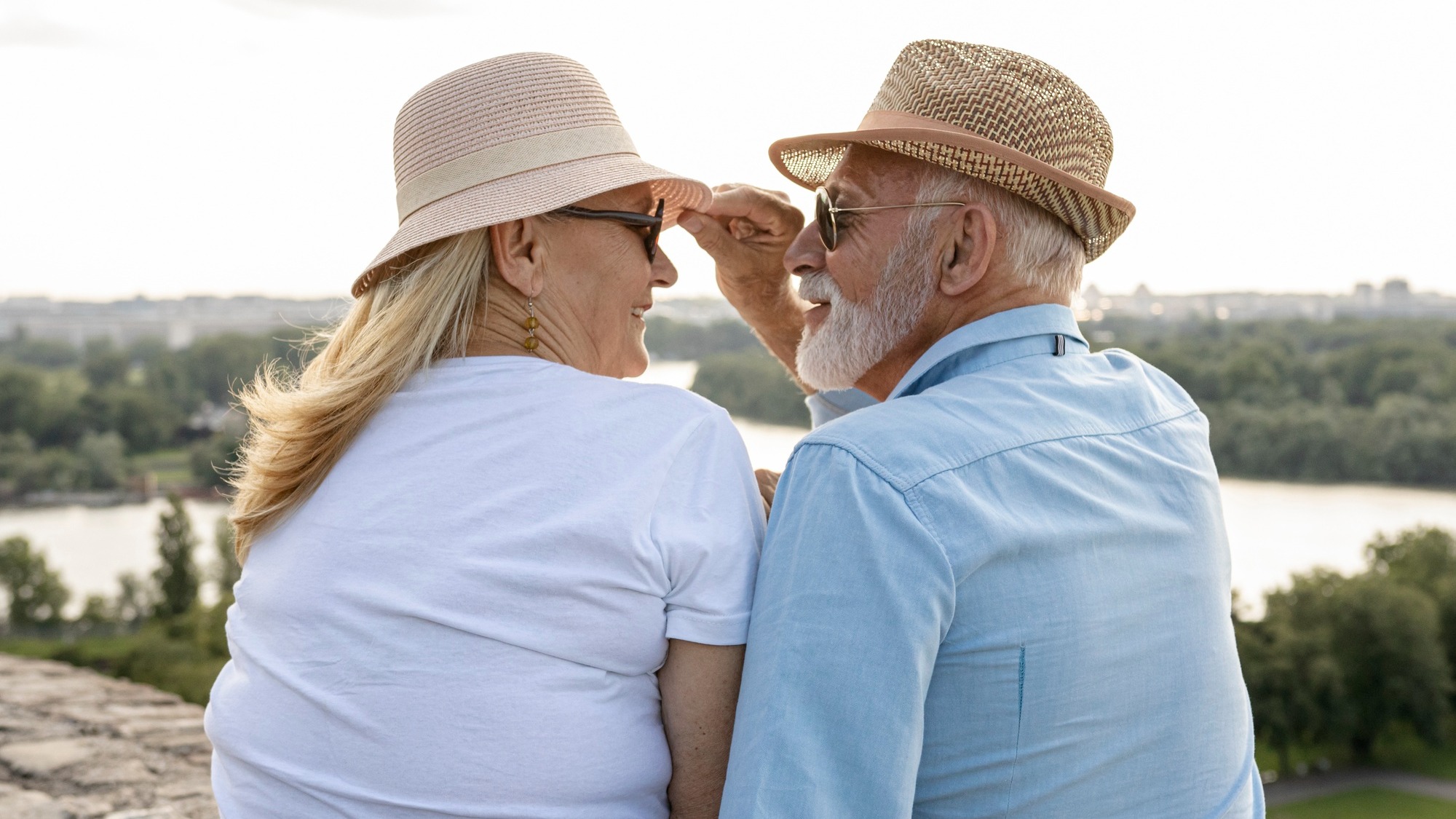 Old man grabbing a woman's hat
