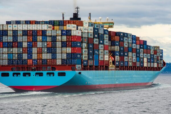 blue and red cargo ship on sea during daytime