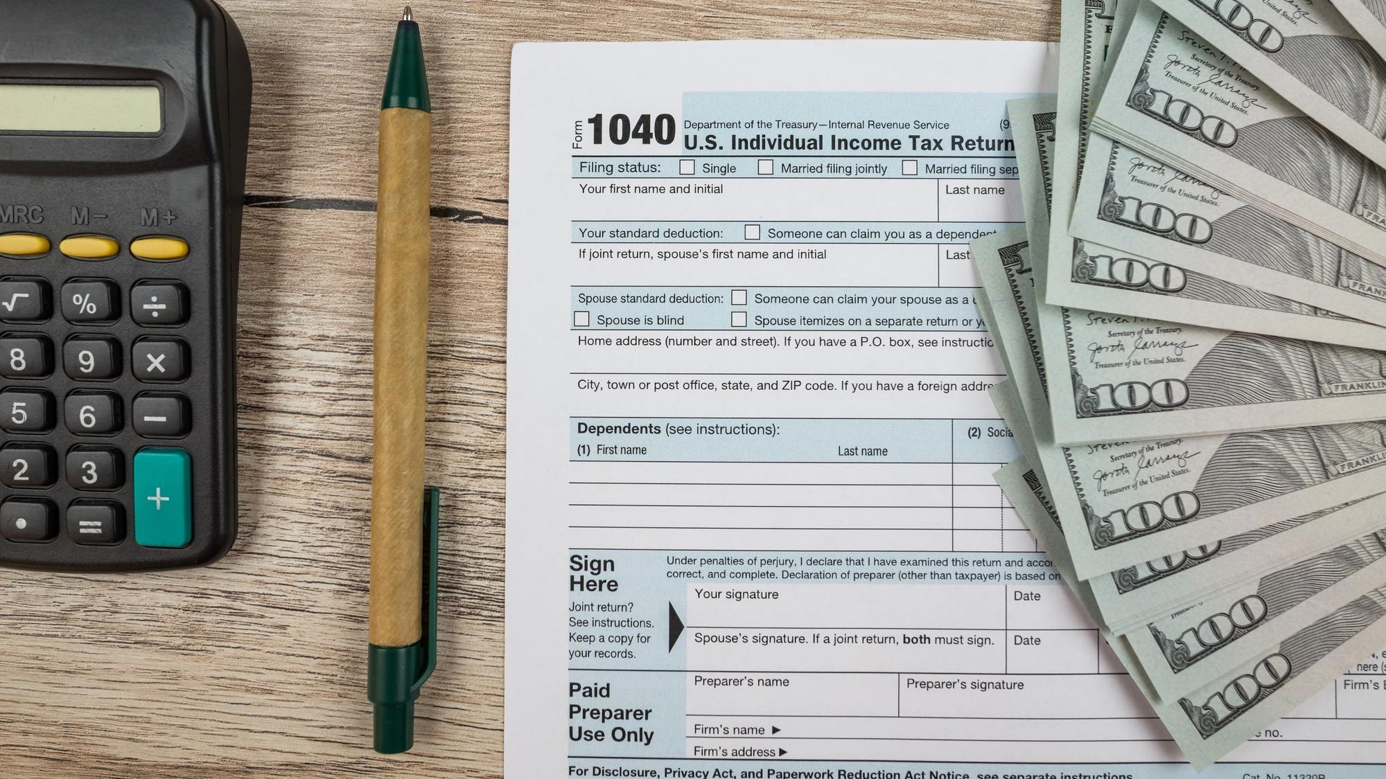 1040 tax form on a wooden table Tax time Financial concept