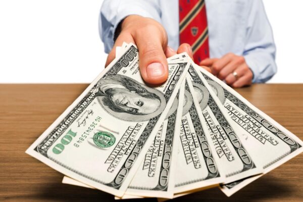 Businessman with money in hand, US dollar (USD) bills - investment,