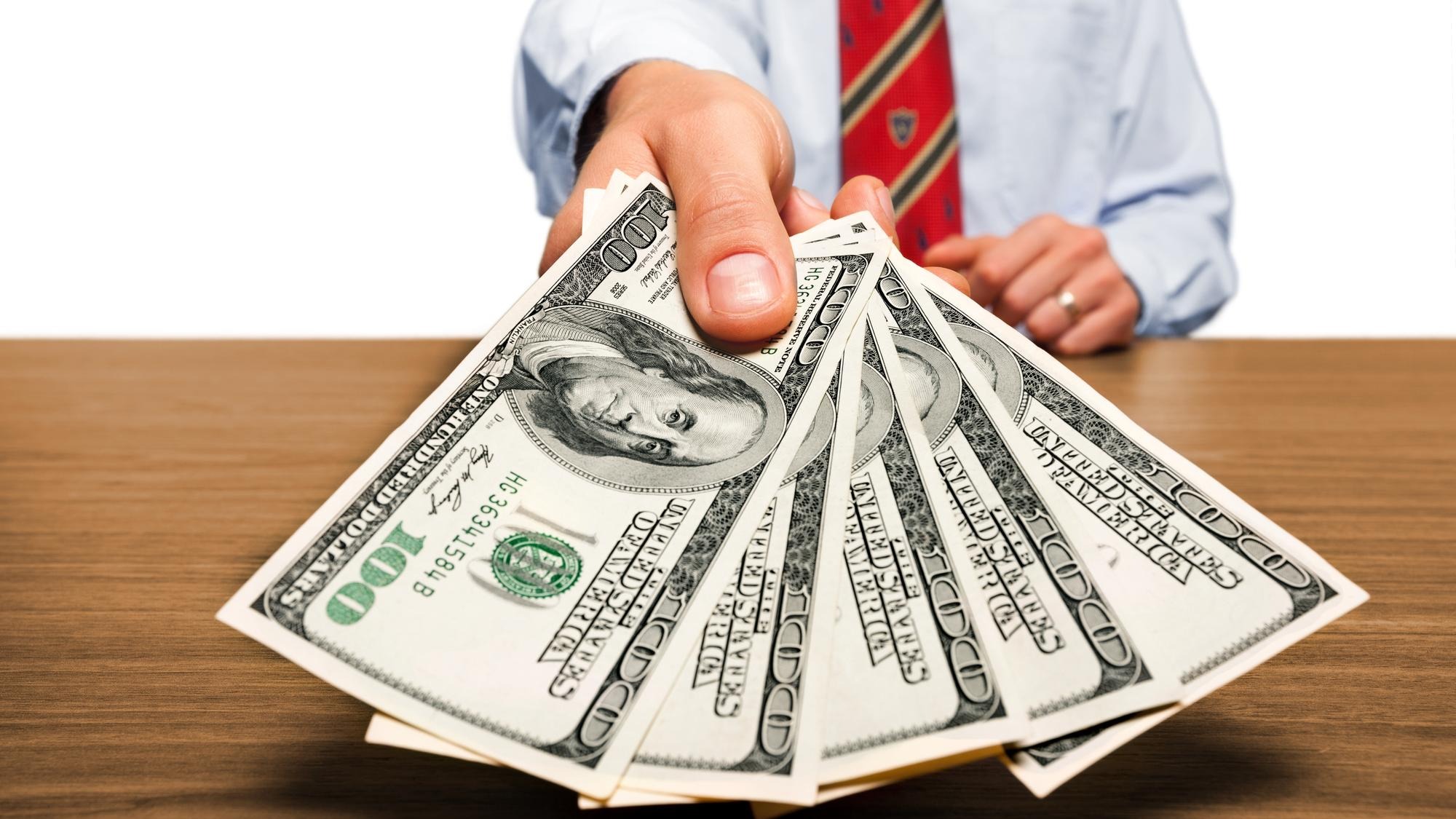 Businessman with money in hand, US dollar (USD) bills - investment,