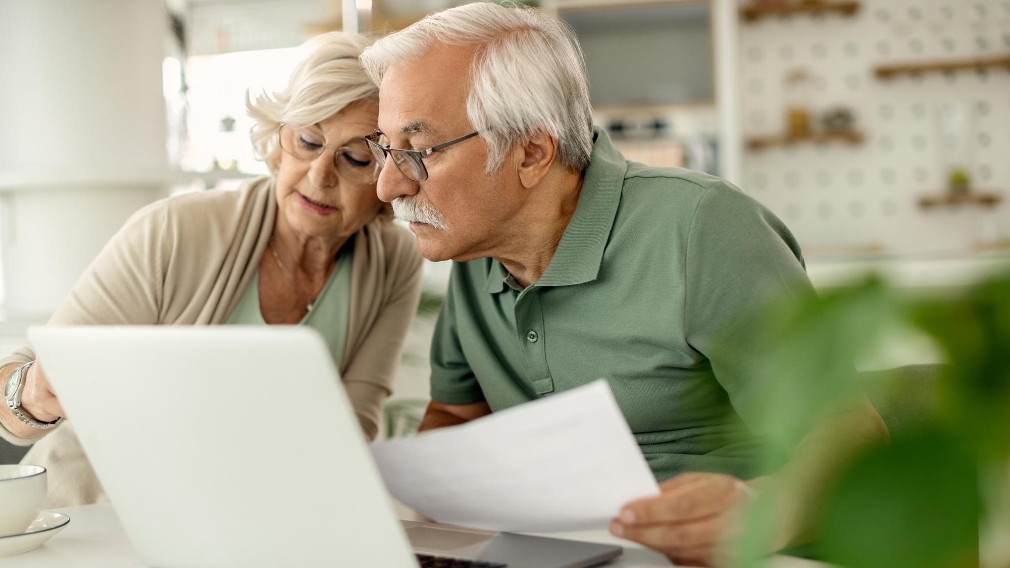 Senior couple analyzing their savings while going through home finances