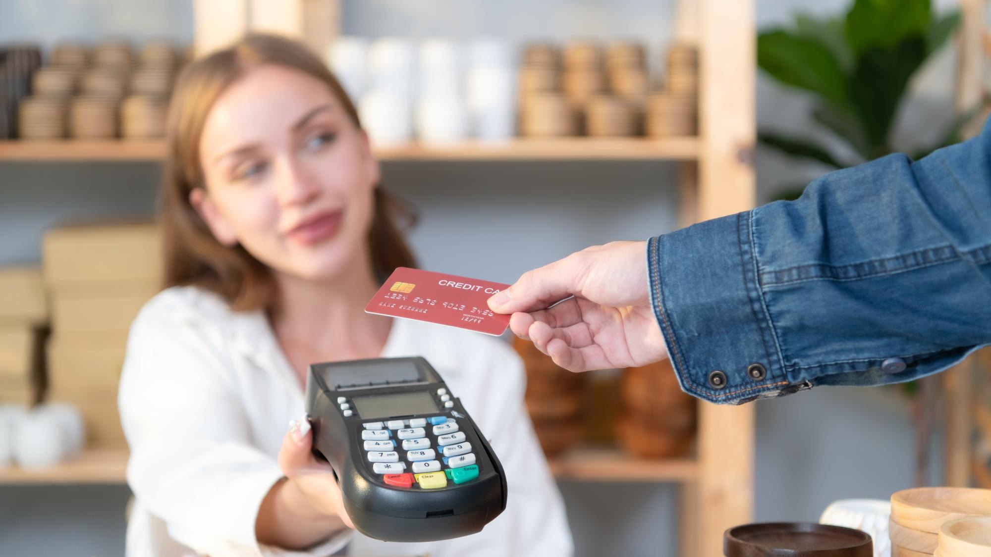 Young woman small business owner with a credit card payment system