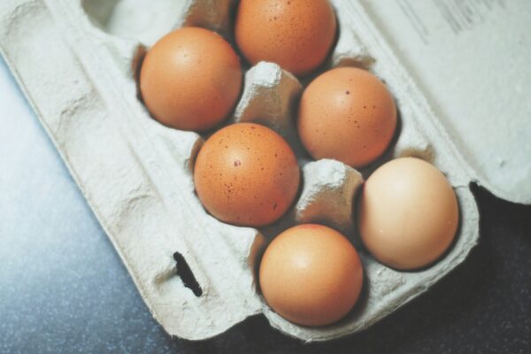 seven brown eggs on tray