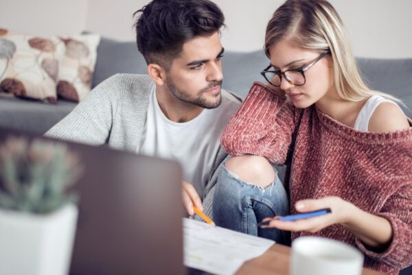 Young couple calculating their domestic bills at home