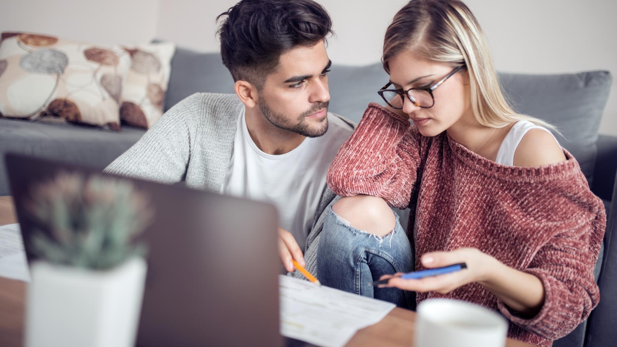 Young couple calculating their domestic bills at home