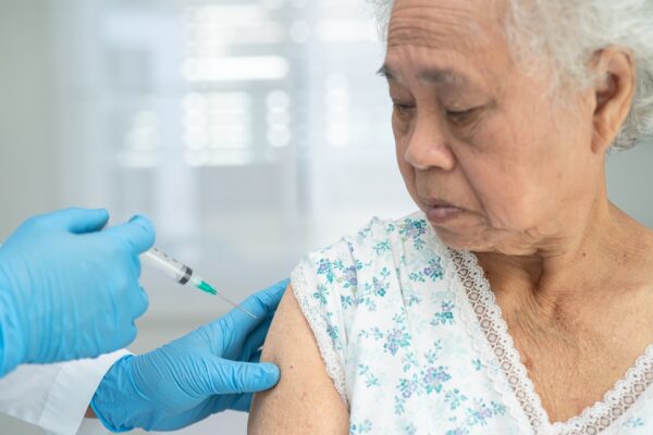 Elderly Asian senior woman getting covid19 or coronavirus vaccine by doctor