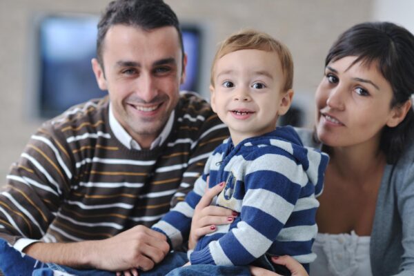 happy young family have fun and relaxing at new home with bright furniture