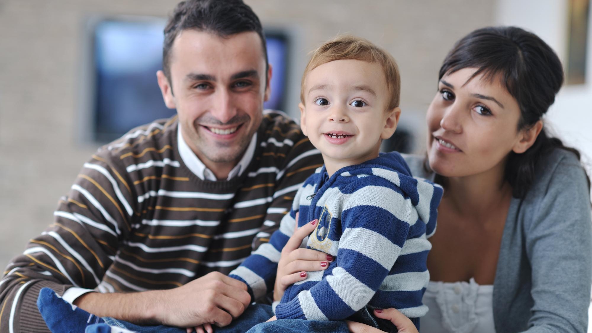 happy young family have fun and relaxing at new home with bright furniture