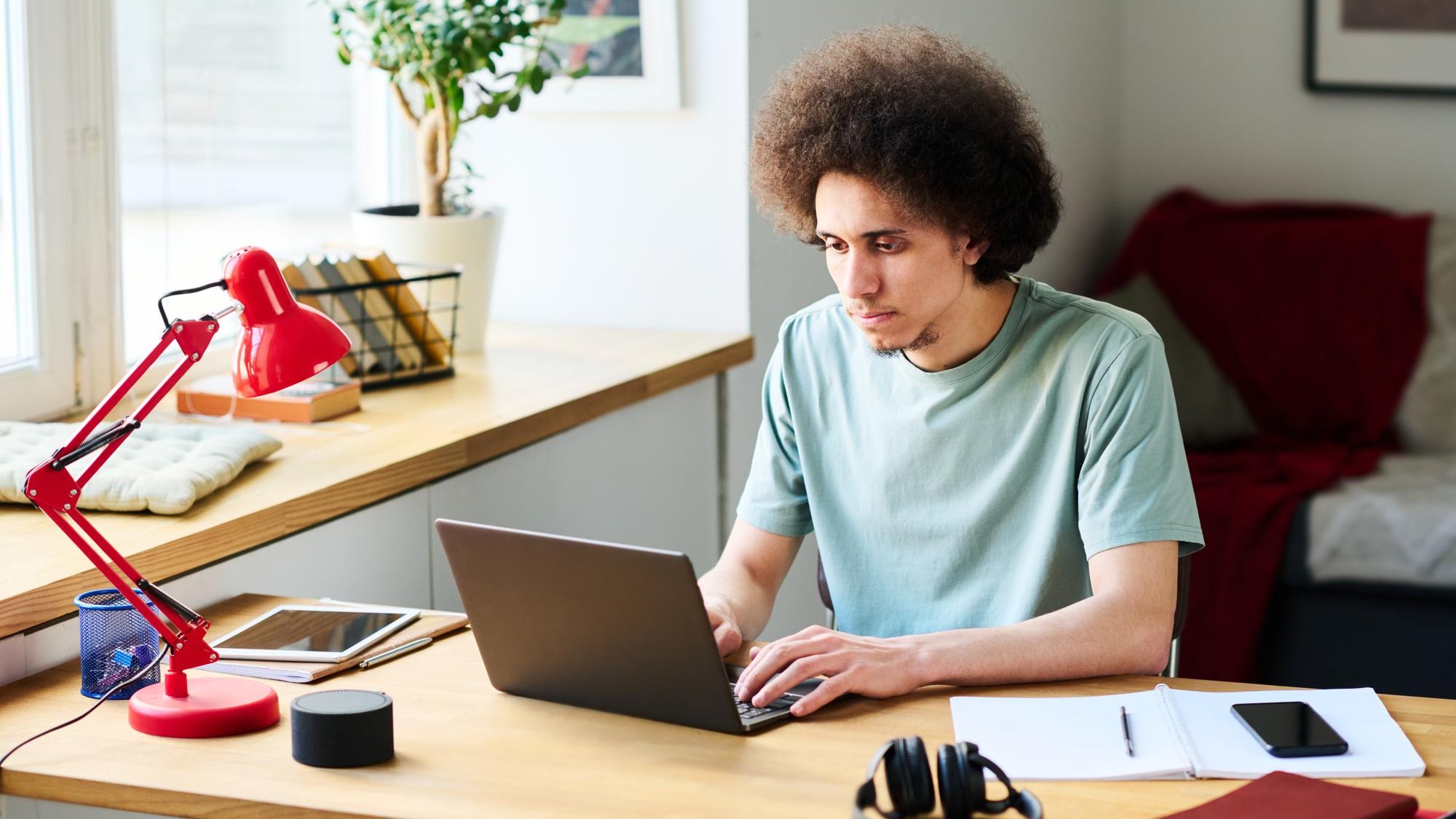 Young man working online on laptop at home