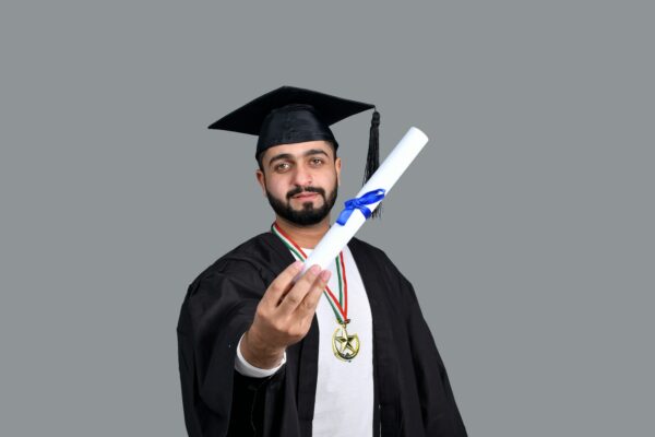 a man wearing a graduation cap and gown holding a diploma
