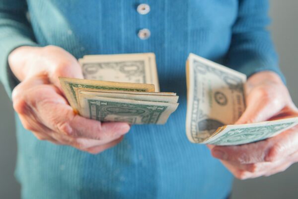 Hands holding us dollar bills