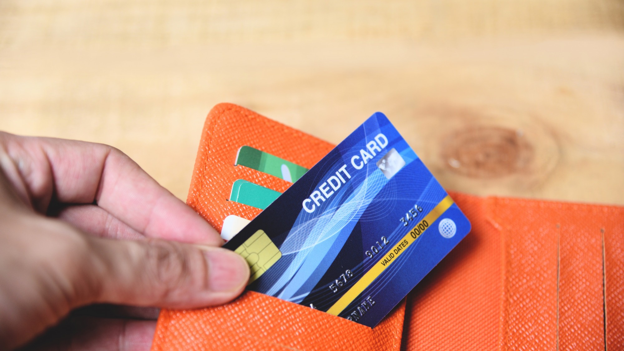 Credit card in wallet with hand