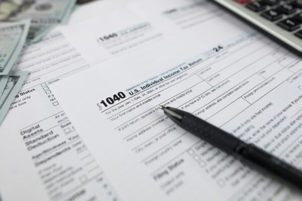 Tax form 1040 on dark wooden background financial document