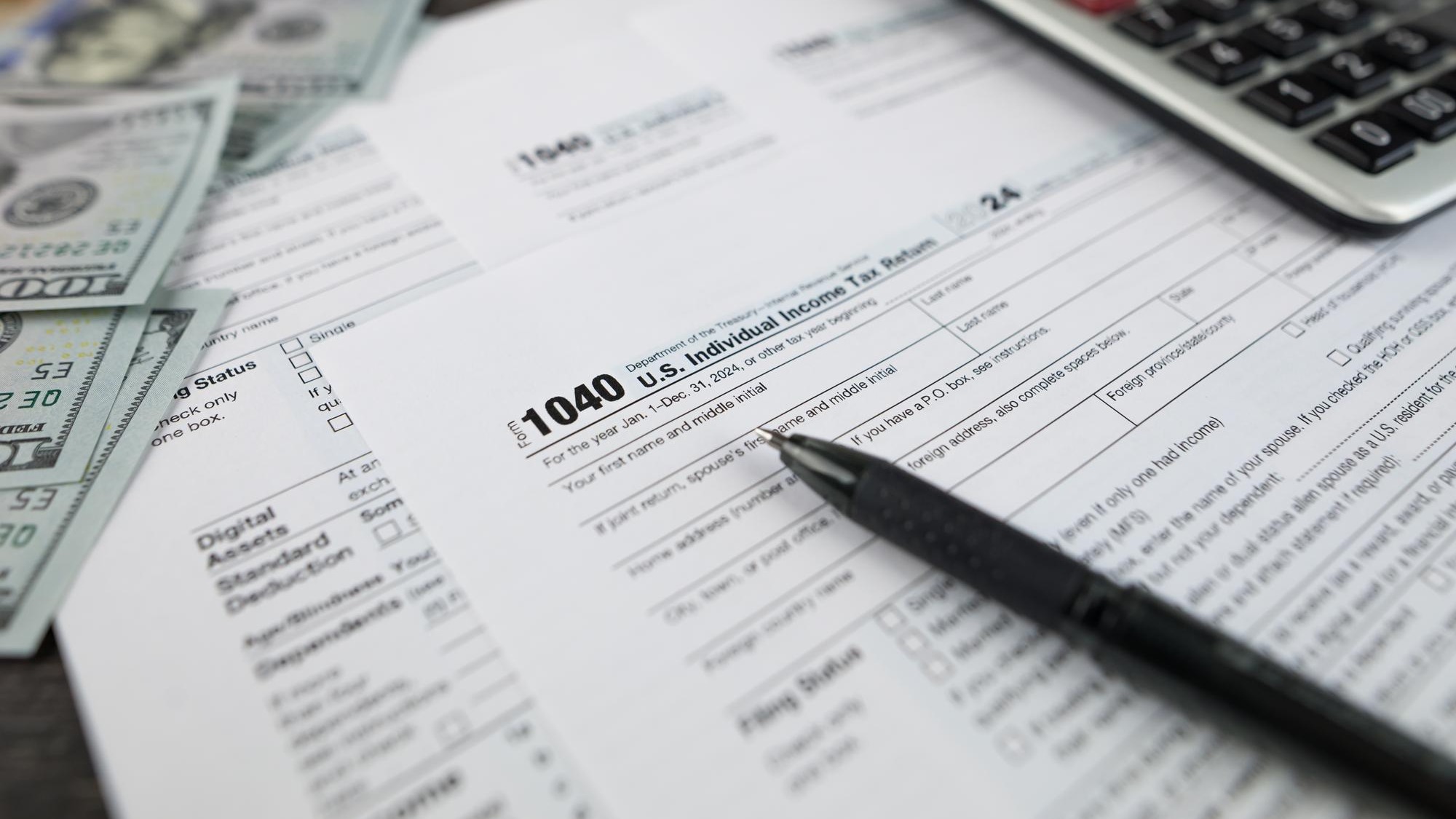 Tax form 1040 on dark wooden background financial document