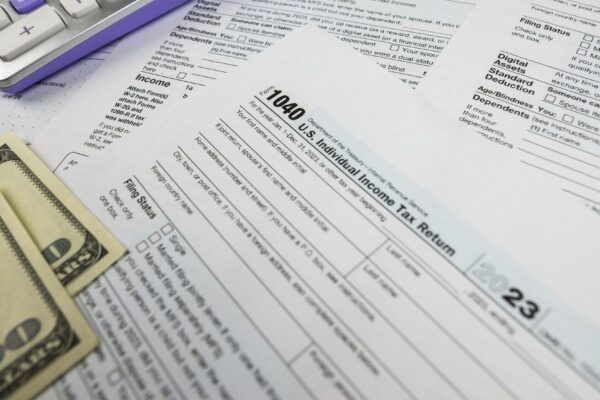 Tax form 1040 with calculator and dollars