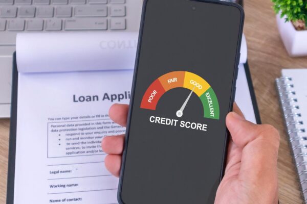 Male hand holding a cellphone to check his credit score to apply for a loan to the bank