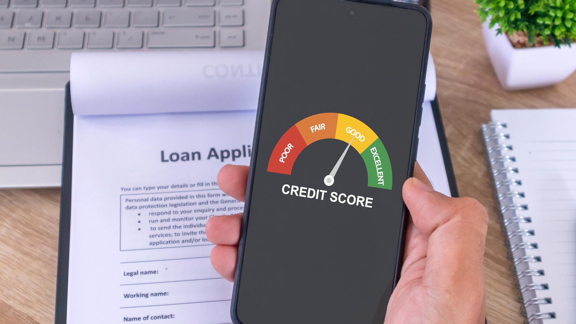 Male hand holding a cellphone to check his credit score to apply for a loan to the bank