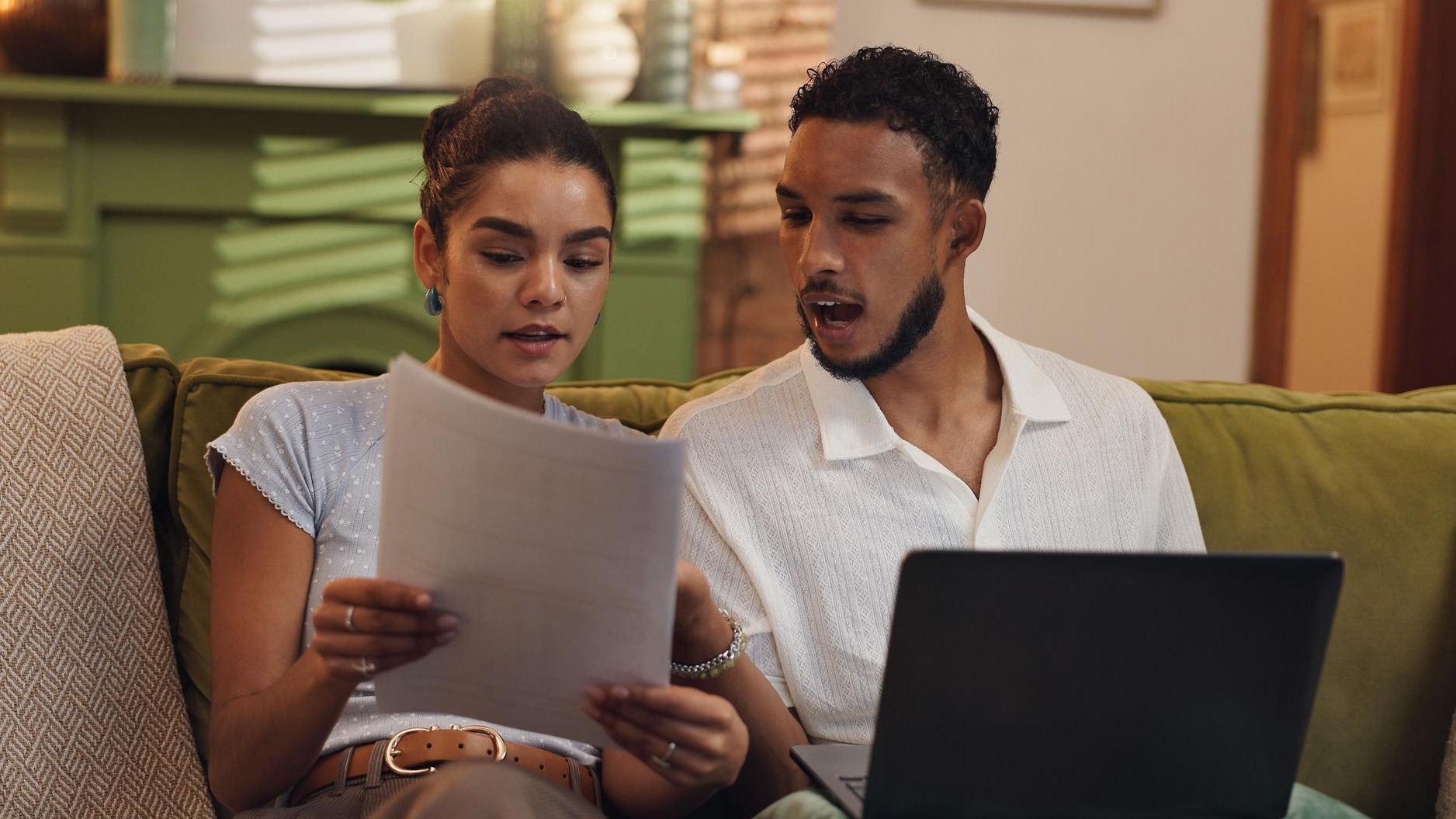 Couple finance and documents with laptop on sofa for budget planning expenses or bills at home Man woman or paperwork with computer for mortgage payment cost or financial invoices at house