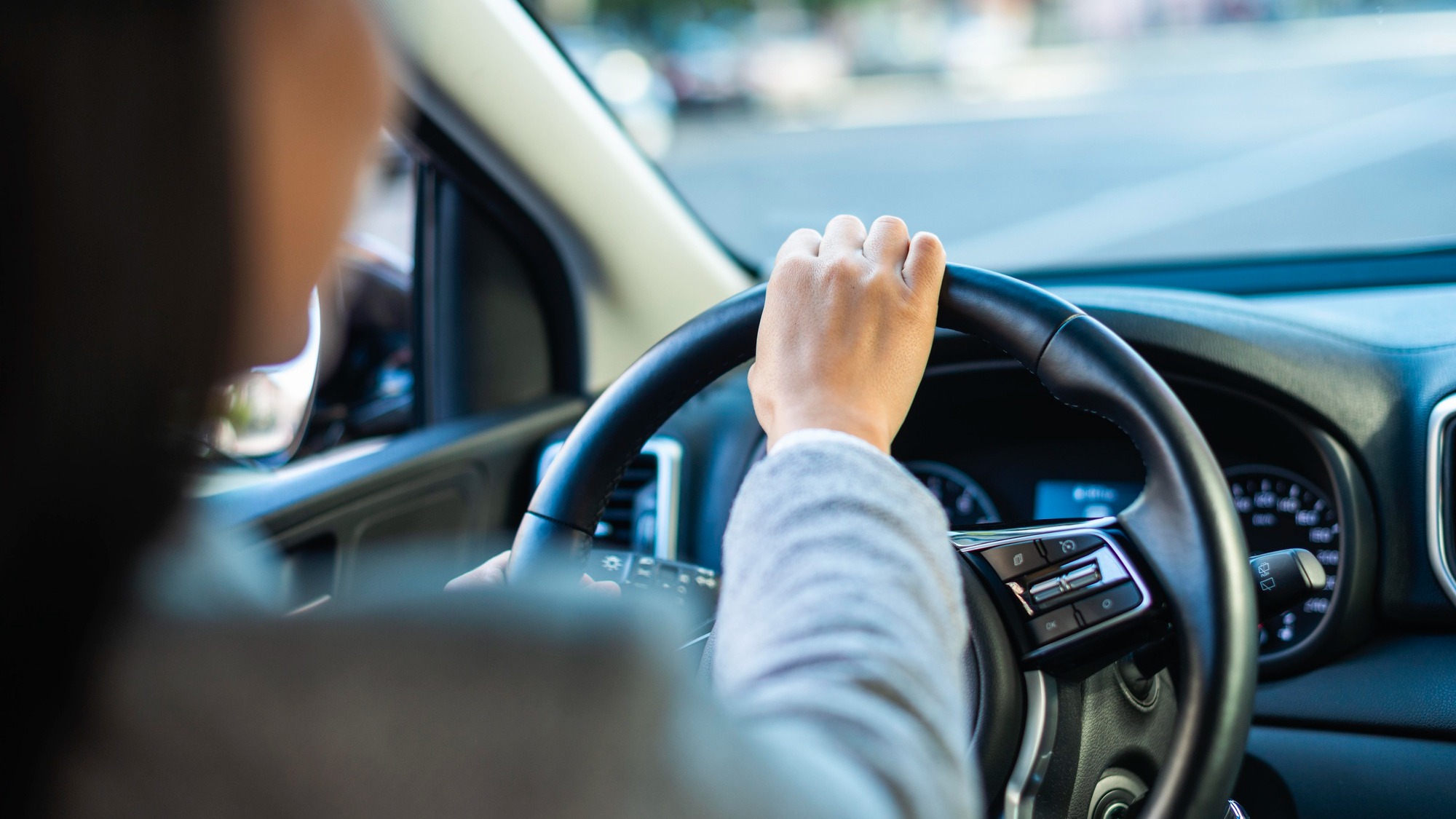 Businesswoman driving her car in the city