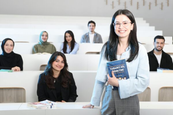 Group of diverse university students in a bright lecture hall, studying language education.