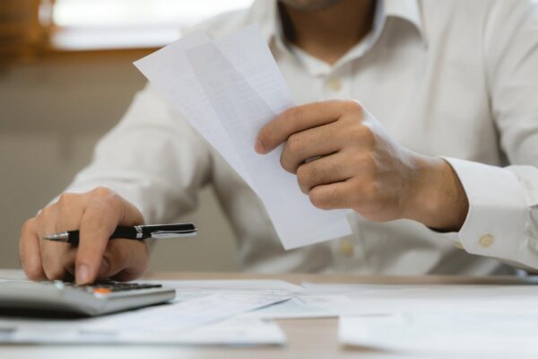 Close up hand of professional accountant review tax paperwork