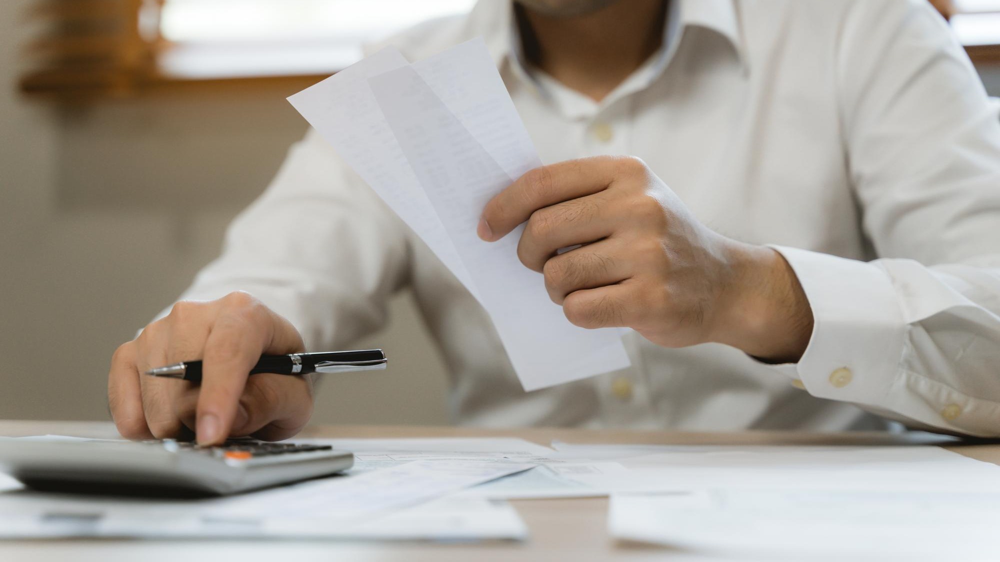 Close up hand of professional accountant review tax paperwork