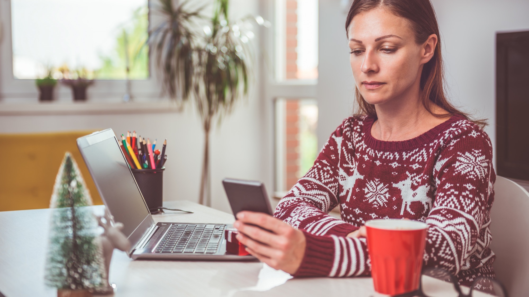 Women using smart phone in the home office