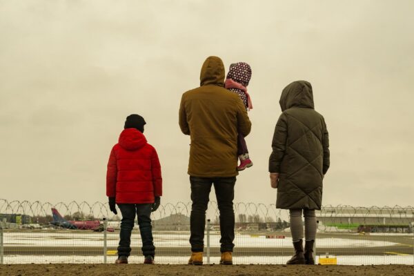 Family together is watching planes take off and landing next to airport