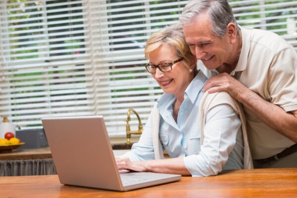 Senior couple using the laptop together