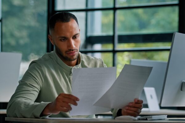 Pensive leader company ceo boss thinking african businessman manager auditor checking documents
