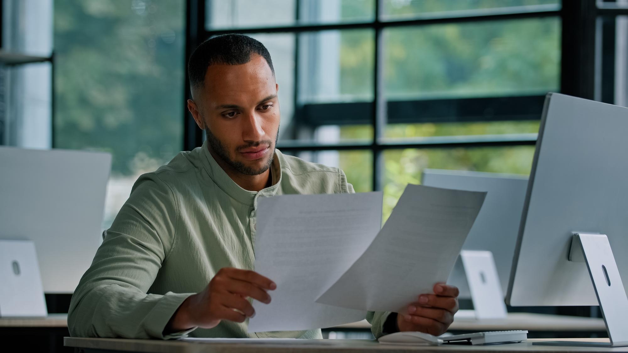 Pensive leader company ceo boss thinking african businessman manager auditor checking documents