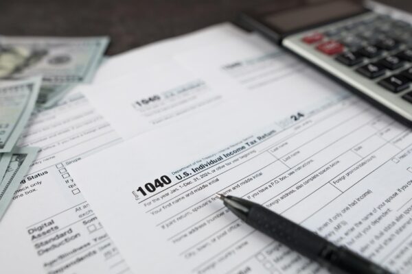 Tax form 1040 on dark wooden background financial document