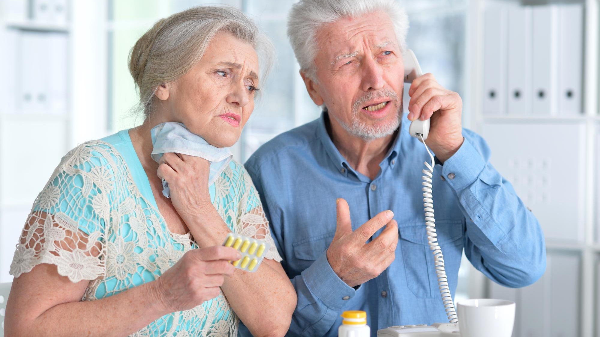 An elderly couple is sick and takes medication at home