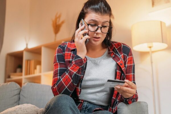 Banking problem mobile service shocked woman angry woman talking on phone worried with bank fraud