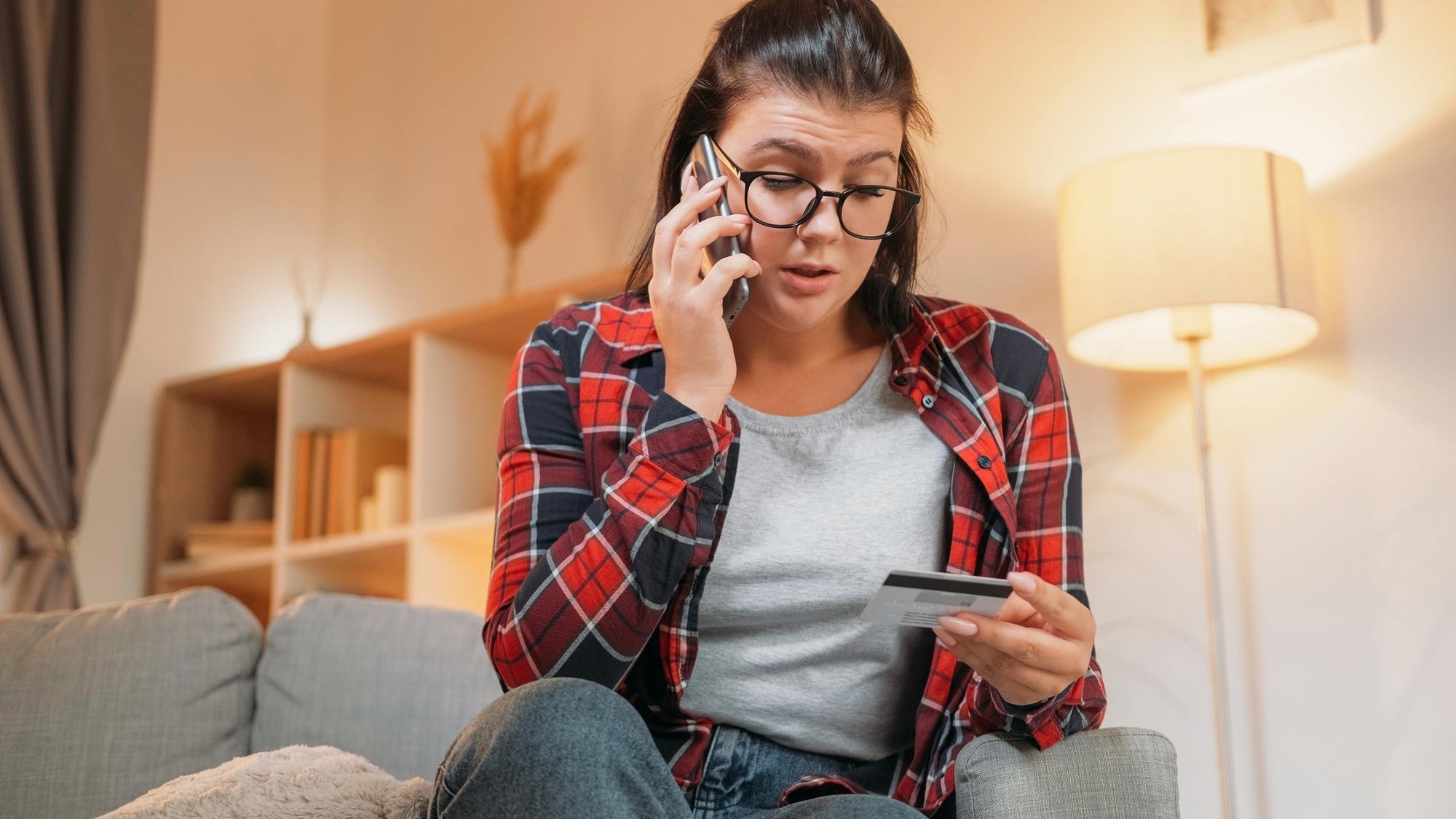 Banking problem mobile service shocked woman angry woman talking on phone worried with bank fraud
