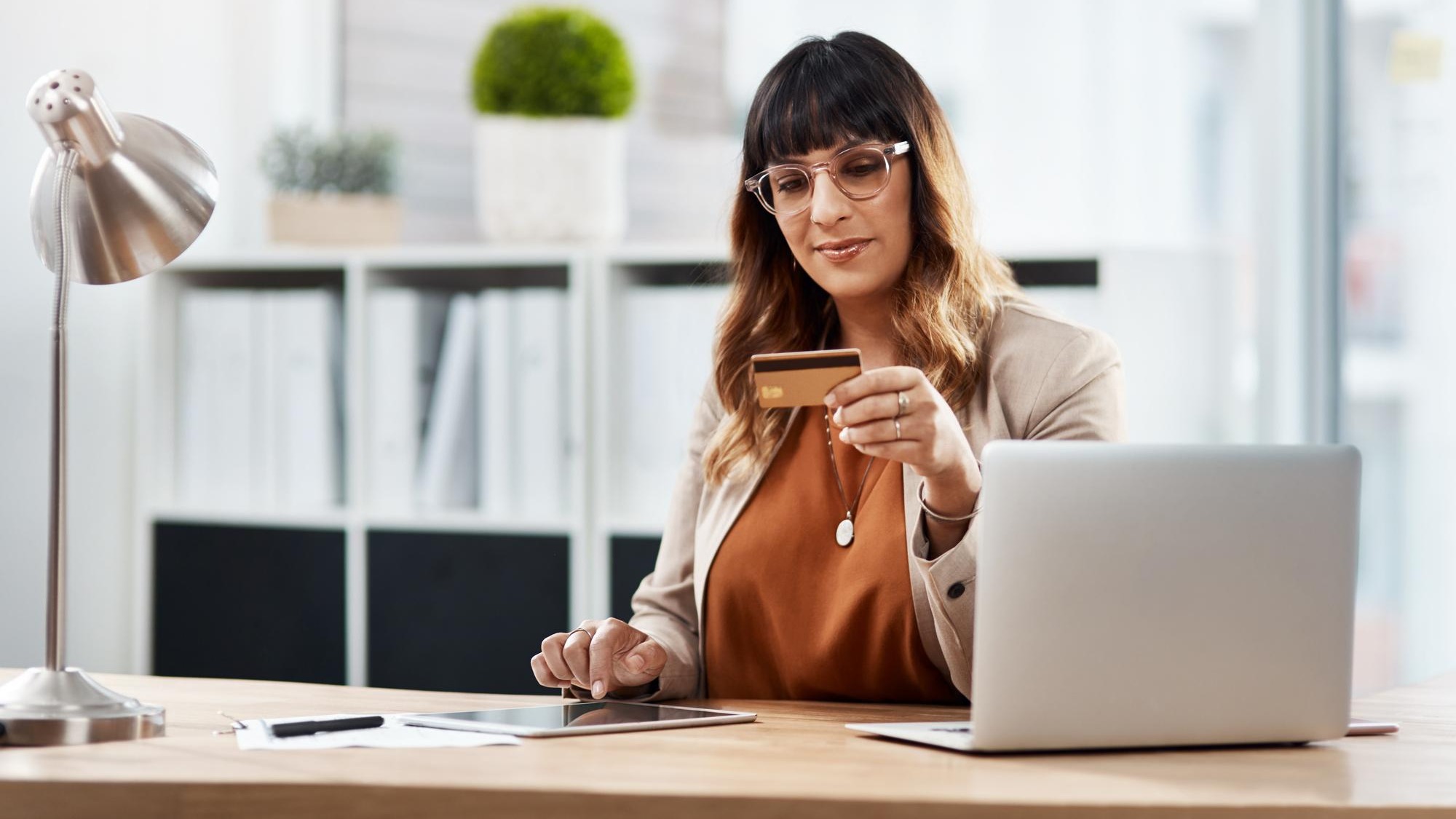 Woman credit card and tablet in office with online shopping app or typing with info sale or deal Person touchscreen and fintech for easy banking click or ecommerce with bills budget or finance