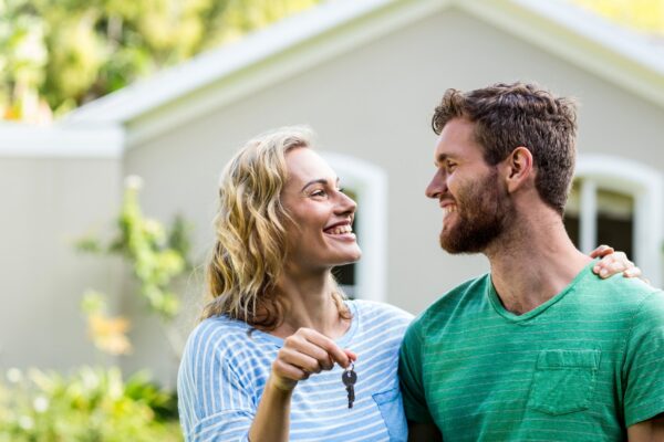Couple looking each other while holding keys
