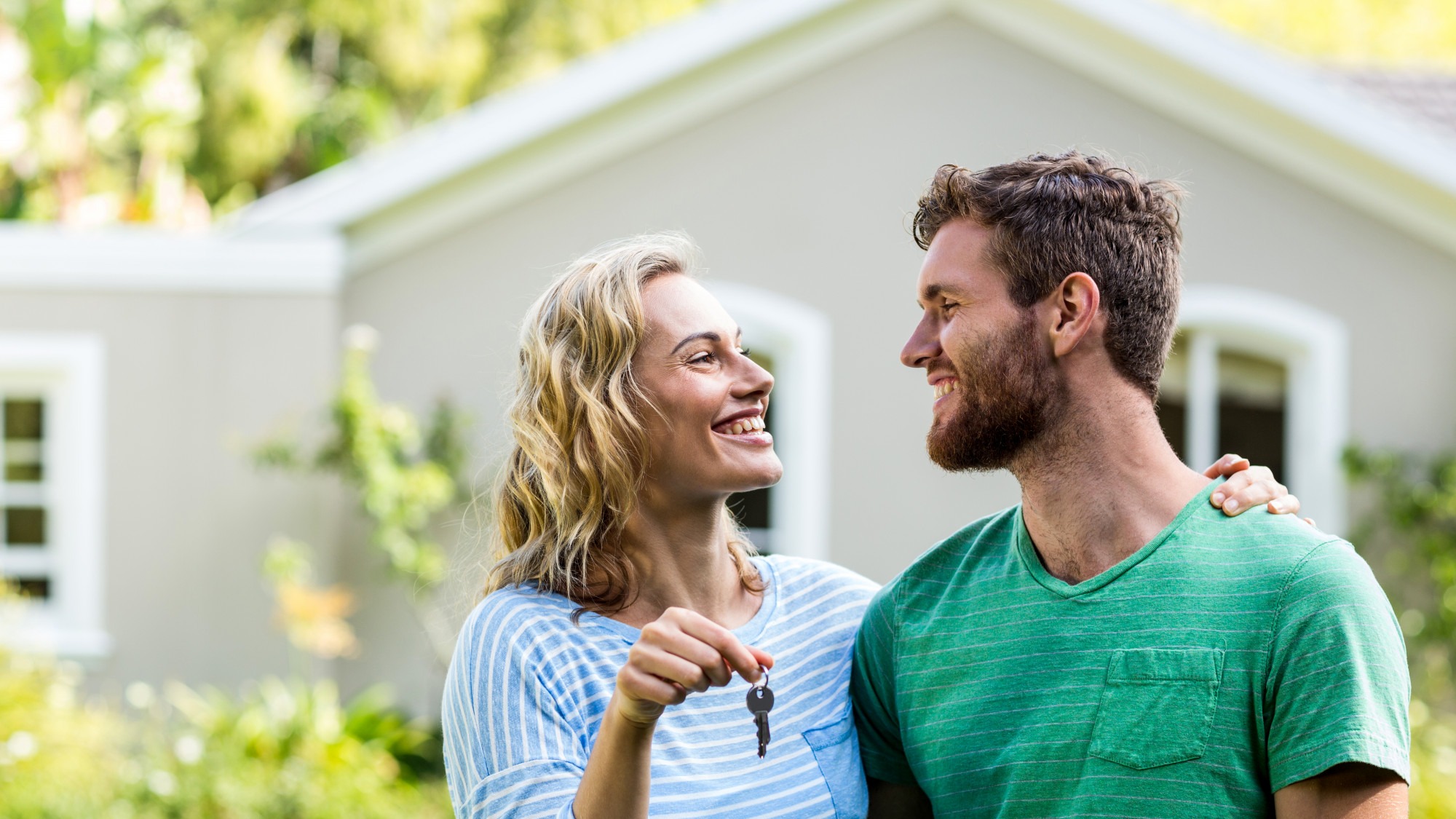 Couple looking each other while holding keys