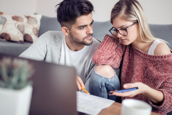 Young couple calculating their domestic bills at home