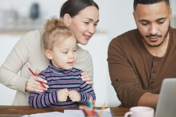 Mixed-Race Family Using Laptop at Home