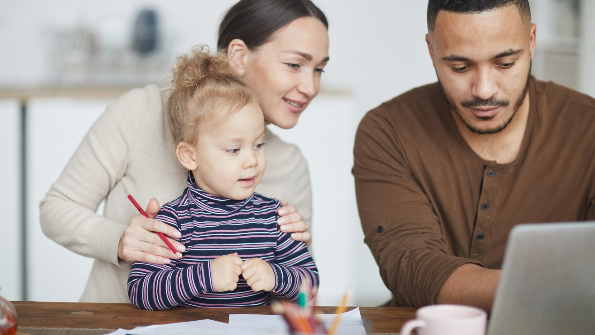 Mixed-Race Family Using Laptop at Home